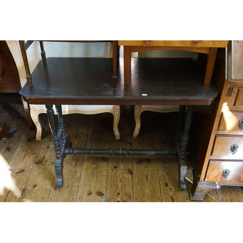 556 - A Victorian Stained as Mahogany Table on turned Column. Measuring: 90cms across x 46cms deep x 68cms... 