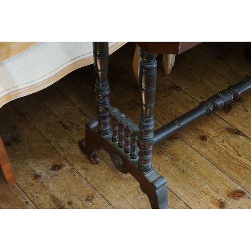 556 - A Victorian Stained as Mahogany Table on turned Column. Measuring: 90cms across x 46cms deep x 68cms... 