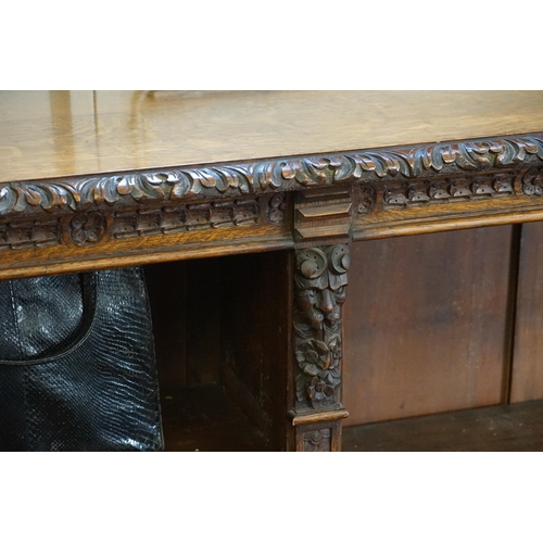 557 - A Victorian Carved Oak Bookcase in the Jacobean style with carved Front. Measuring: 175cms across x ... 