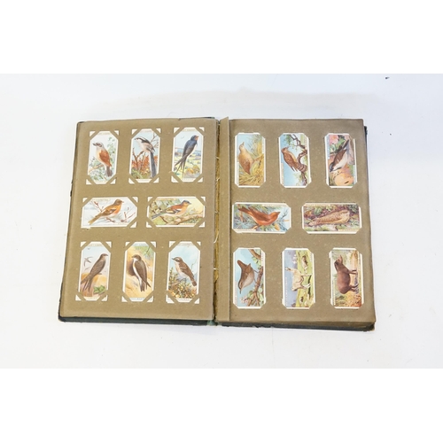 335 - An Early Cigarette Card Album containing various 