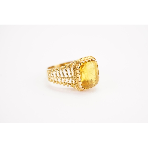 153 - A 18ct gold Citrine set ring, set with a emerald cut Citrine. Size N. Weight 4.9g.