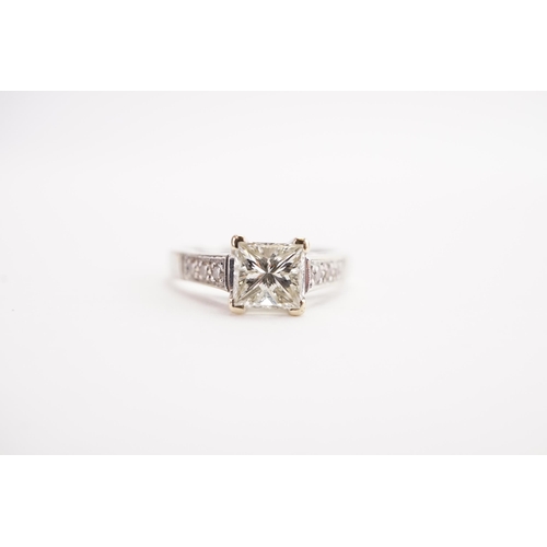 155 - A 18ct white gold princess cut diamond ring, set with a 0.7ct princess cut diamond, and diamond shou... 