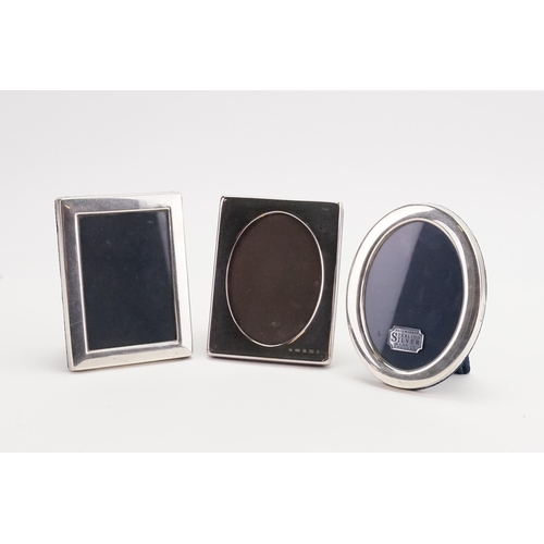 66 - A collection of three small silver photo frames.