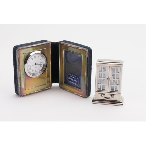 237 - A silver quartz travel clock along with one other.