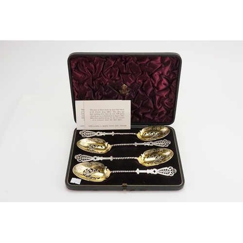 87 - A cased set of four silver Elkington & Company 1890 serving spoons. Twist and pierced design with go... 