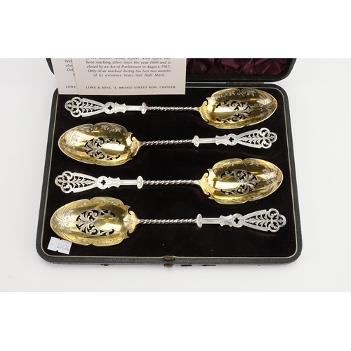 87 - A cased set of four silver Elkington & Company 1890 serving spoons. Twist and pierced design with go... 