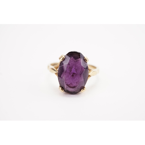 159 - A 9ct gold oval amethyst set ring. Weight 4.3g. Size R.