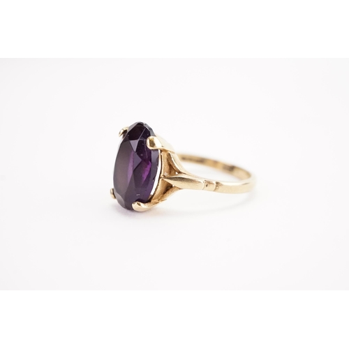 159 - A 9ct gold oval amethyst set ring. Weight 4.3g. Size R.