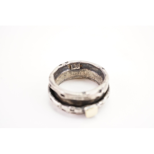 162 - A interesting silver coloured white metal oriental ring. Weight 7.7g. Size M.