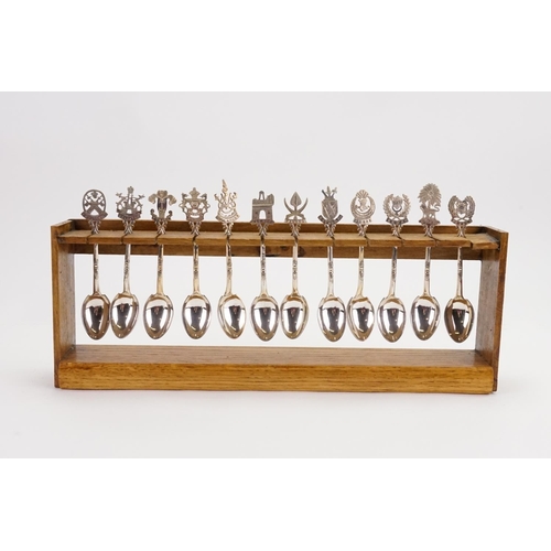 101 - A Collection of 12 Malaysian Silver Coloured White Metal Spoons depicting State Crests contained on ... 