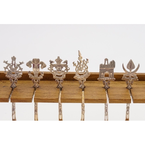 101 - A Collection of 12 Malaysian Silver Coloured White Metal Spoons depicting State Crests contained on ... 