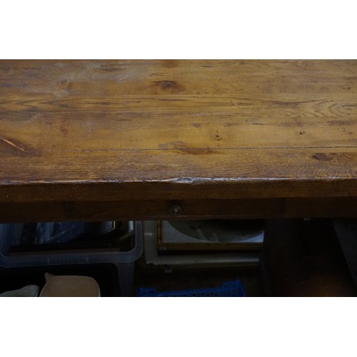 565 - A Country Made Oak Drawer Leaf Refractory Dining Table resting on square legs. Measuring: 91cms x 13... 