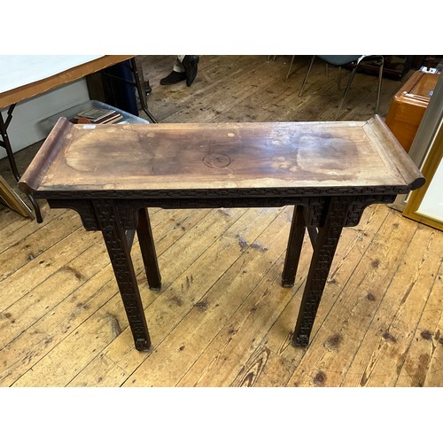 555 - A Japanese Hardwood Scroll Table with a Key Carved Bordered Front resting on Square Legs. Measuring:... 