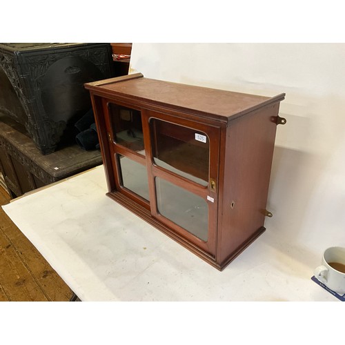 525 - A Mahogany Double Sliding Doored Glass Cabinet. Measuring: 61cms across x 47cms high x 25cms deep.