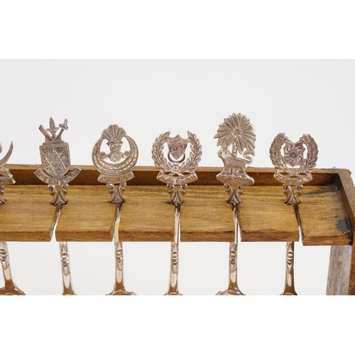 10 - A Collection of 12 Malaysian Silver Coloured White Metal Spoons depicting State Crests contained on ... 