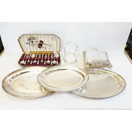 72 - Three Silver Plated Flats, an Entre Dish & Cover, a Warming Stand & a Cased Set of Cuttlery.