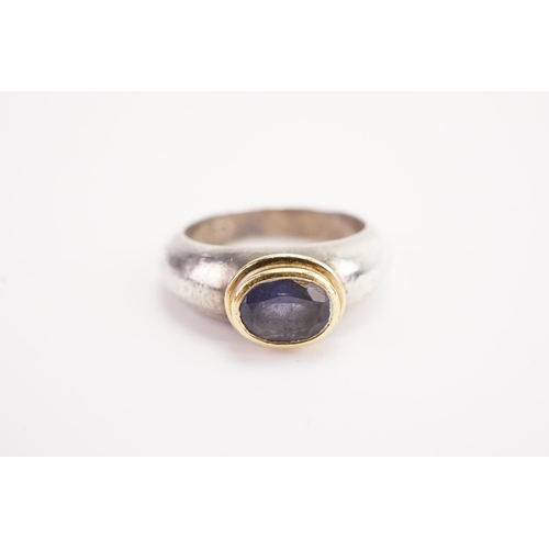 181 - A silver and gold coloured mounted set ring, set with a purple stone. Weight 9.4g. Size O.