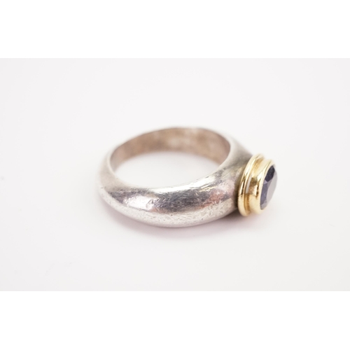 181 - A silver and gold coloured mounted set ring, set with a purple stone. Weight 9.4g. Size O.