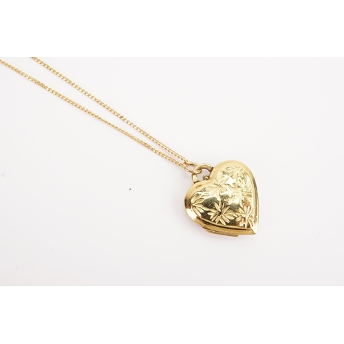 136 - A 9ct chain, hung with a love heart locket. Weight of chain 1.6g.