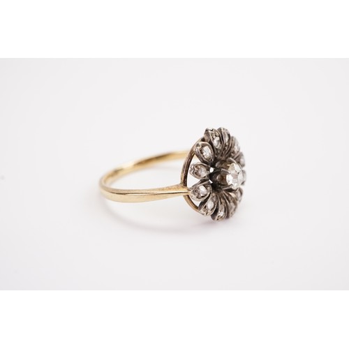 138 - A 18ct gold diamond set floral ring, set with a 0.15ct old mine cut diamond, surrounded by 12 chip d... 