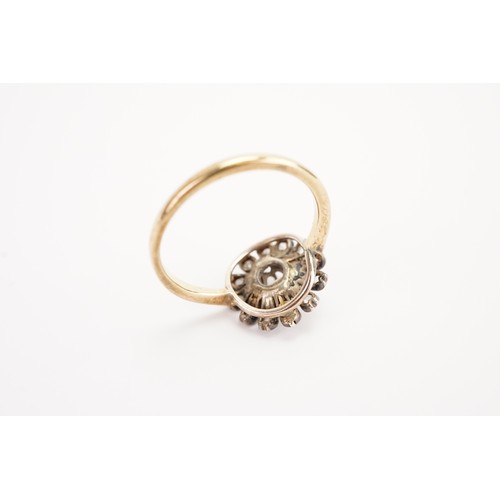 138 - A 18ct gold diamond set floral ring, set with a 0.15ct old mine cut diamond, surrounded by 12 chip d... 