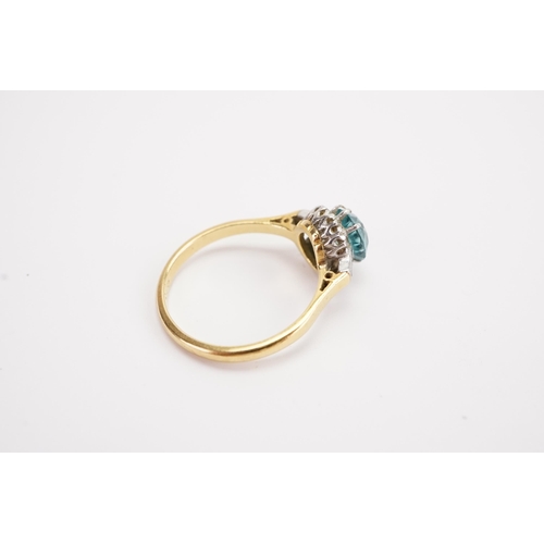 139 - A 18ct gold and platinum set Zircon ring, surrounded by two baguette diamonds and 8 brilliant cut di... 