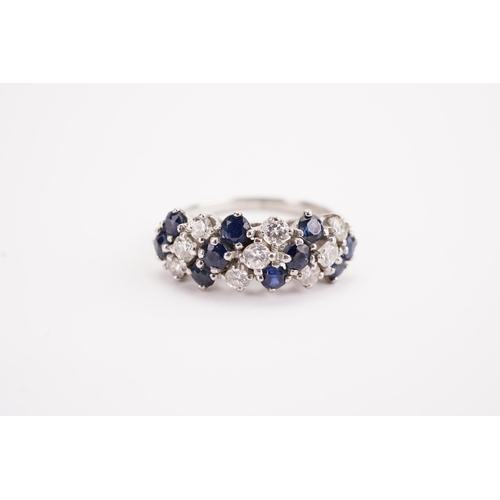 140 - A 18ct white gold sapphire and diamond set ring, largest stones approximately 0.15ct. Weight 5.4g. S... 