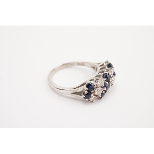 140 - A 18ct white gold sapphire and diamond set ring, largest stones approximately 0.15ct. Weight 5.4g. S... 