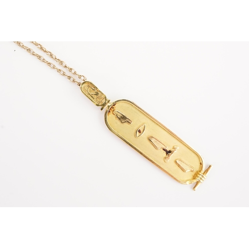 99 - An Egyptian hallmarked pendant (9ct or higher). Weight 4.4g. Hung on a 9ct gold chain. Weight 3.9g.