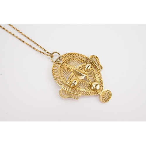 114 - A 14ct gold thin chain (1.5g). Along with a filigree pendant.