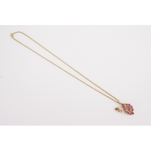 120 - A 9ct gold ruby set pendant, hung on a 9ct gold chain. Along with a single earring. Weight 5.9g.