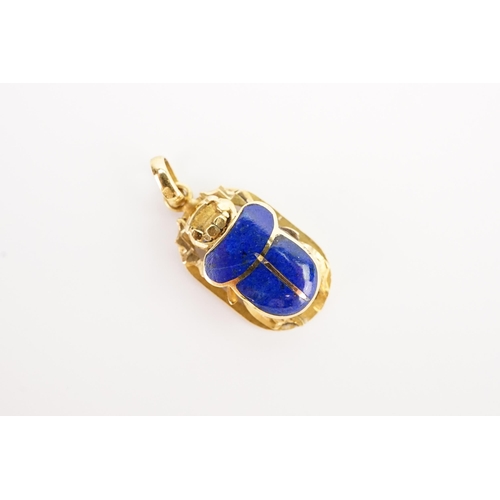 121 - A interesting lapis lazuli set scarab, Egyptian marked. Weight 4.1g.