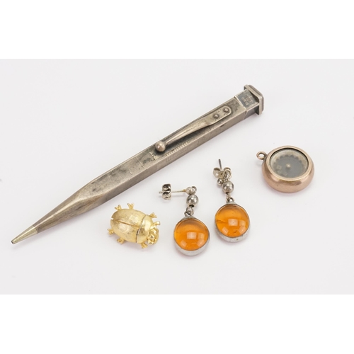 177 - A pair of amber coloured earrings, along with a miniature dice shaker, silver pencil, and a beetle.