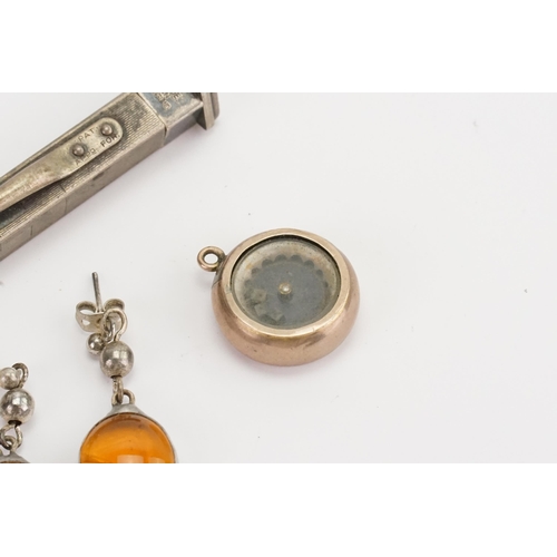 177 - A pair of amber coloured earrings, along with a miniature dice shaker, silver pencil, and a beetle.