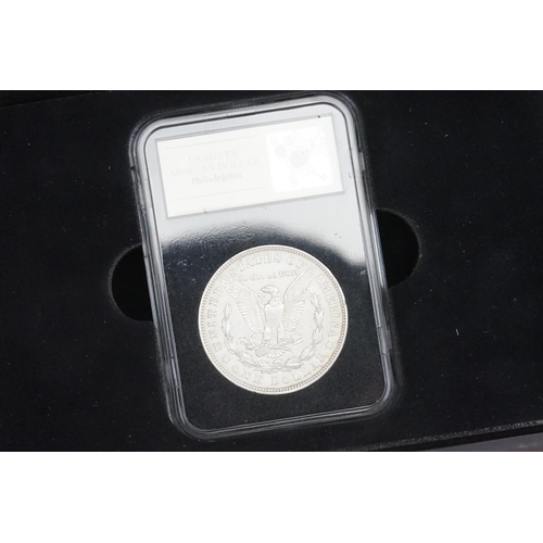 259 - A cased US Philadelphia Silver Morgan Dollar dated 1921, in presentation box, by coin portfolio. Alo... 