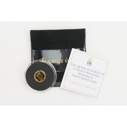 260 - A Jubilee mint Queen Elizabeth II longest reigning monarch 9ct gold coin. Weight 1g.