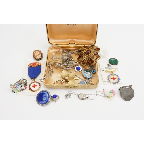 172 - A collection of costume jewellery, to include a silver cross, brooches, bracelets etc.