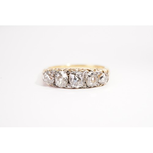 137 - A 18ct gold diamond set ring, set with five old mine cut diamonds, the largest approximately 0.5ct. ... 