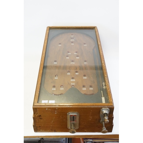 850 - An Early 20th Century Table Top Bagatelle Game in oak case with glazed top and coin operated mechani... 