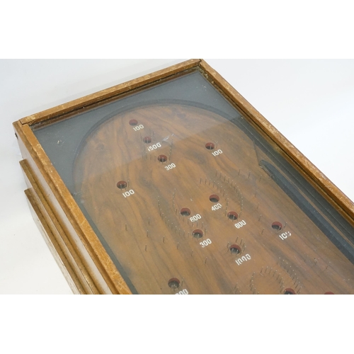 850 - An Early 20th Century Table Top Bagatelle Game in oak case with glazed top and coin operated mechani... 