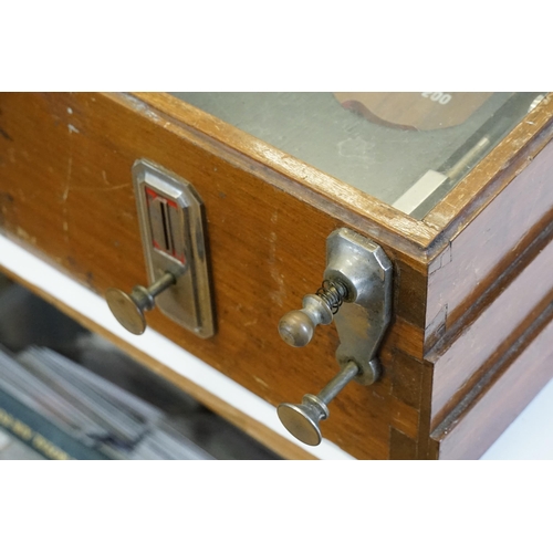 850 - An Early 20th Century Table Top Bagatelle Game in oak case with glazed top and coin operated mechani... 