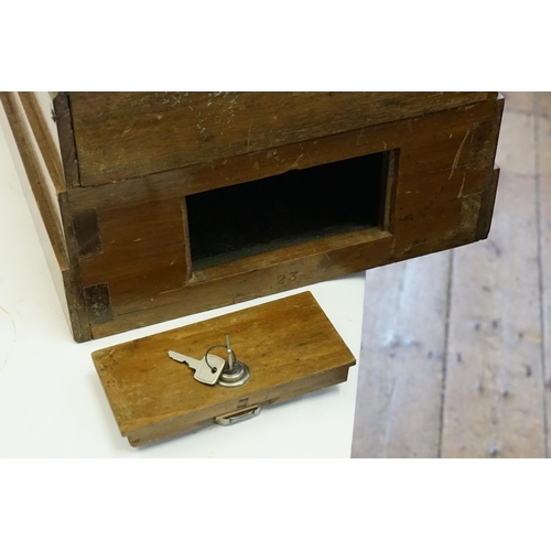 850 - An Early 20th Century Table Top Bagatelle Game in oak case with glazed top and coin operated mechani... 