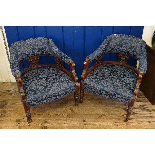 470 - A Pair of Victorian Bow Backed Drawing Room Chairs resting on turned legs.