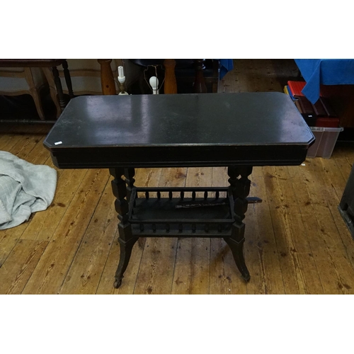 472 - An Aesthetic design Ebonised Fold-Over Top Card Table with under tier. Measuring: 88cms across x 43c... 