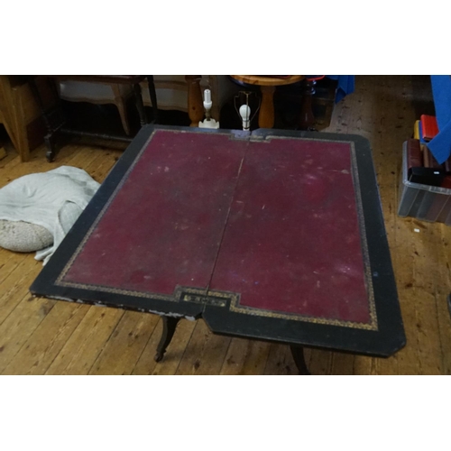 472 - An Aesthetic design Ebonised Fold-Over Top Card Table with under tier. Measuring: 88cms across x 43c... 