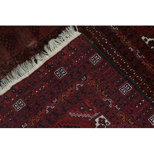 546 - A Red Ground Triple Diagonal Bordered Afghan Rug with a Gold pattern. Measuring: 2.45m x 1.70m.