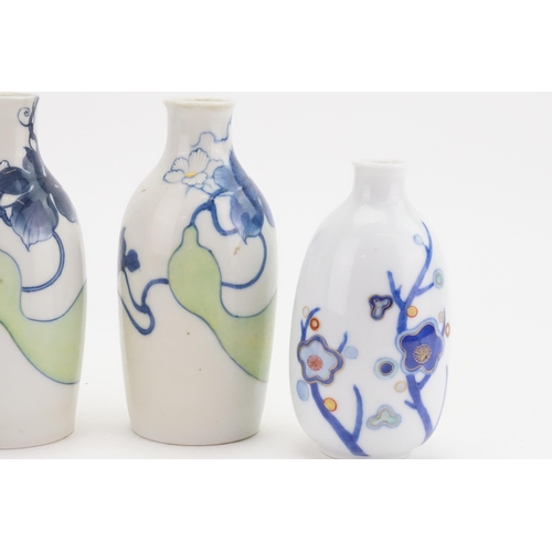 681 - Three Japanese Blue & White Floral decorated Sake Bottles.