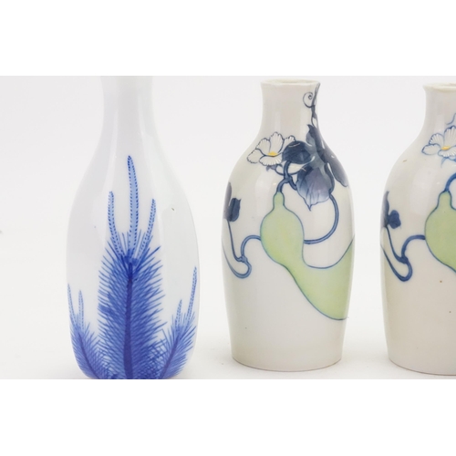 681 - Three Japanese Blue & White Floral decorated Sake Bottles.