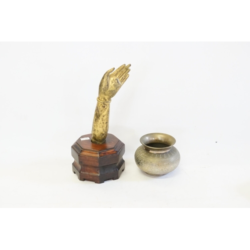 685 - An Indian Brass & patinated Hand of a Buddha contained in a stand & an Indian engraved Ghee Bowl.