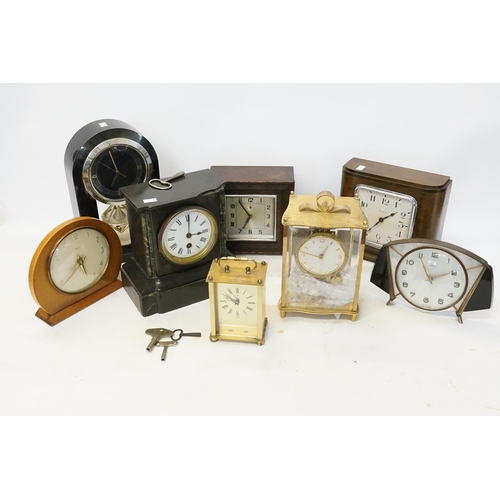 234 - A Kundo brass cased mantle clock, metamec, along with three wooden clocks, marble clock and others.